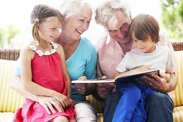 Grandparents reading to their grandchildren