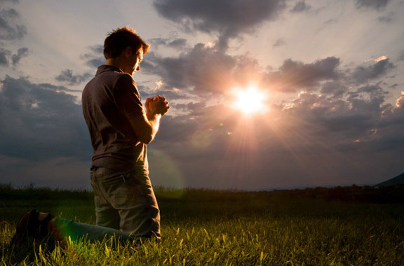 young man
                                                          kneeling in
                                                          prayer