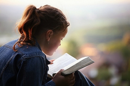 young lady
                  reading Scripture